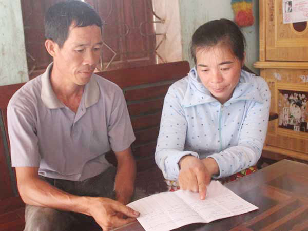 Ông Lý Văn Yên ở thôn Hua Cầu, xã Đông Quan đang được Tổ trưởng Tổ tiết kiệm và vay vốn hướng dẫn gửi tiền tiết kiệm 