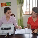 Chị Trần Thị Toàn (bìa phải, buôn bán ở chợ Vũng Tàu) làm thủ tục nhận khoản vay ưu do ngân sách địa phương chuyển sang NHCSXH