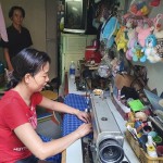 Chị Bùi Ngọc Huệ ở phường 17, quận Bình Thạnh đang may mặc để kiếm thêm thu nhập cho gia đình