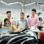 Xưởng may của ông Phạm Văn Thủy ở xã Khánh Trung, huyện Yên Khánh (người đứng giữa) tạo việc làm cho hơn 50 lao động địa phương