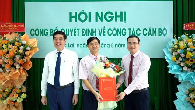 Phó Chủ tịch UBND tỉnh Gia Lai Lâm Hải Giang (bìa trái) cùng Phó Tổng Giám đốc NHCSXH Đoàn Trung Thành (bìa phải) trao Quyết định và chúc mừng Giám đốc chi nhánh NHCSXH tỉnh Gia Lai Nguyễn Minh Hướng